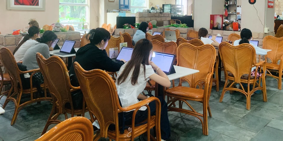 Adult learners seen from behind using tablets during a group pilot session